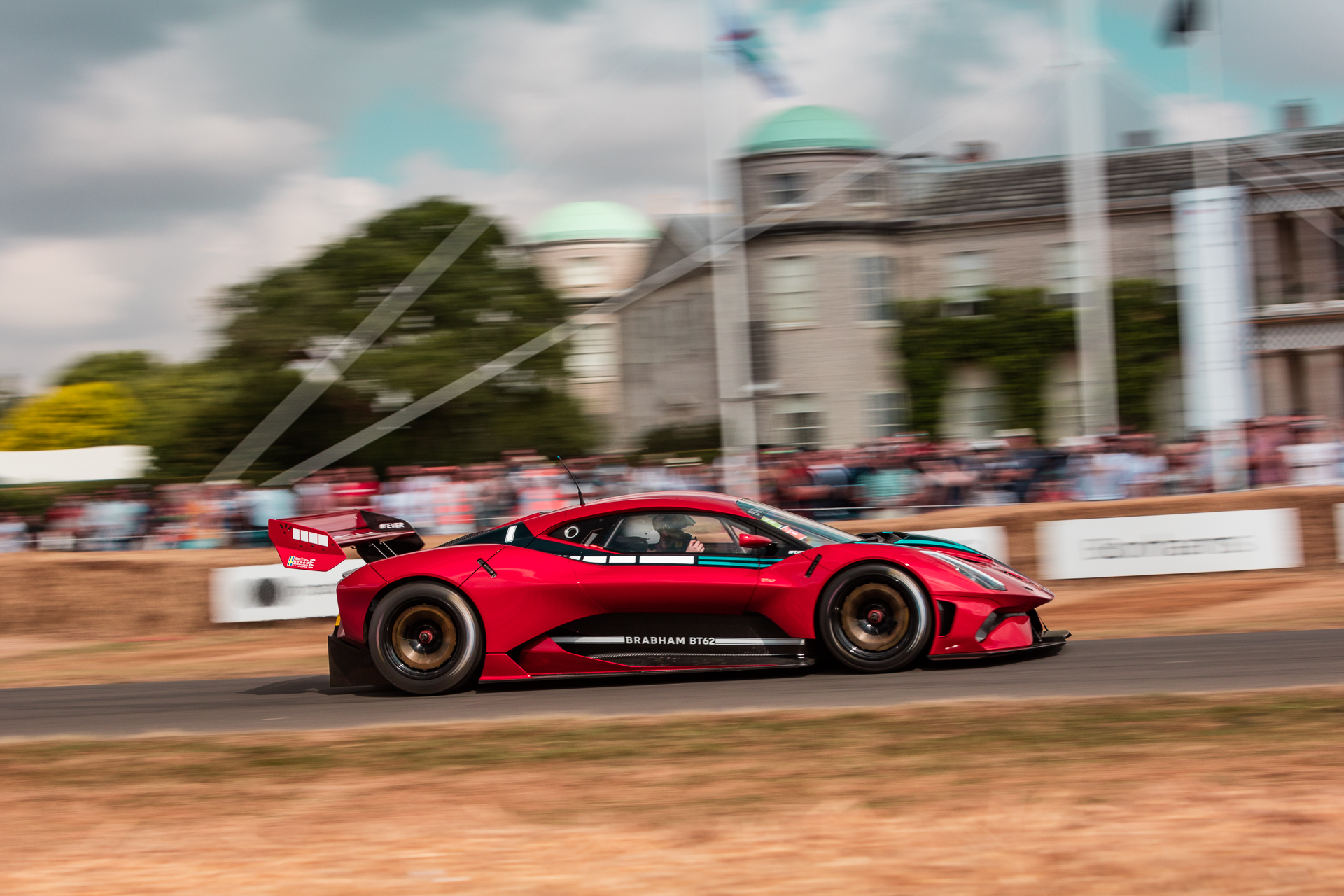 brabham bt-62 on the hill at goodwood transported by mack logistics