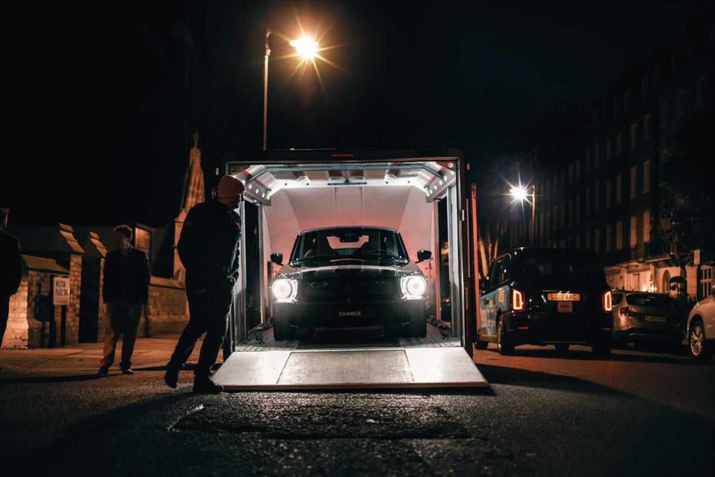 charge cars mustang unloading with Mack Logistics